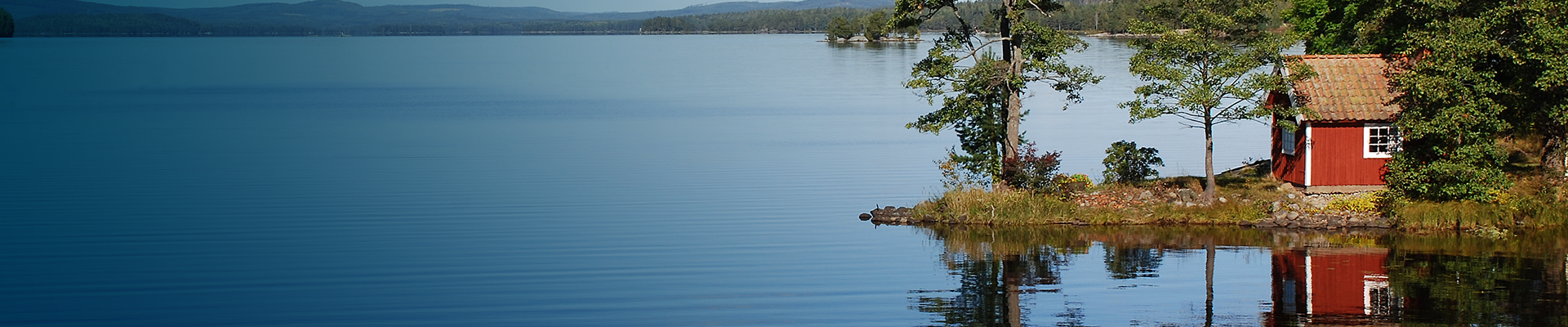 Red log cabin by the sea