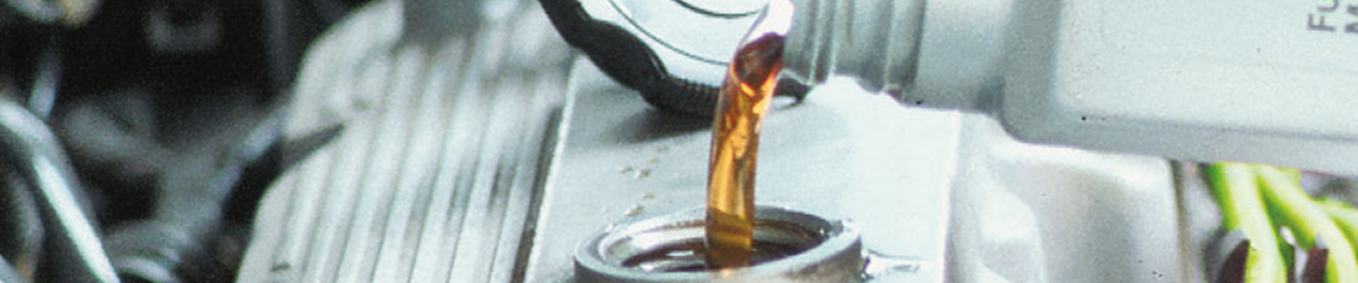 Engine oil being poured into a car engine