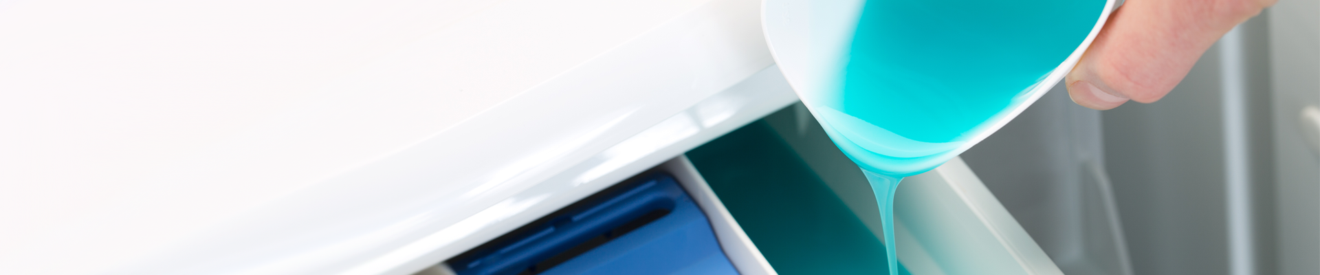 Washing liquid being poured into a washing machine