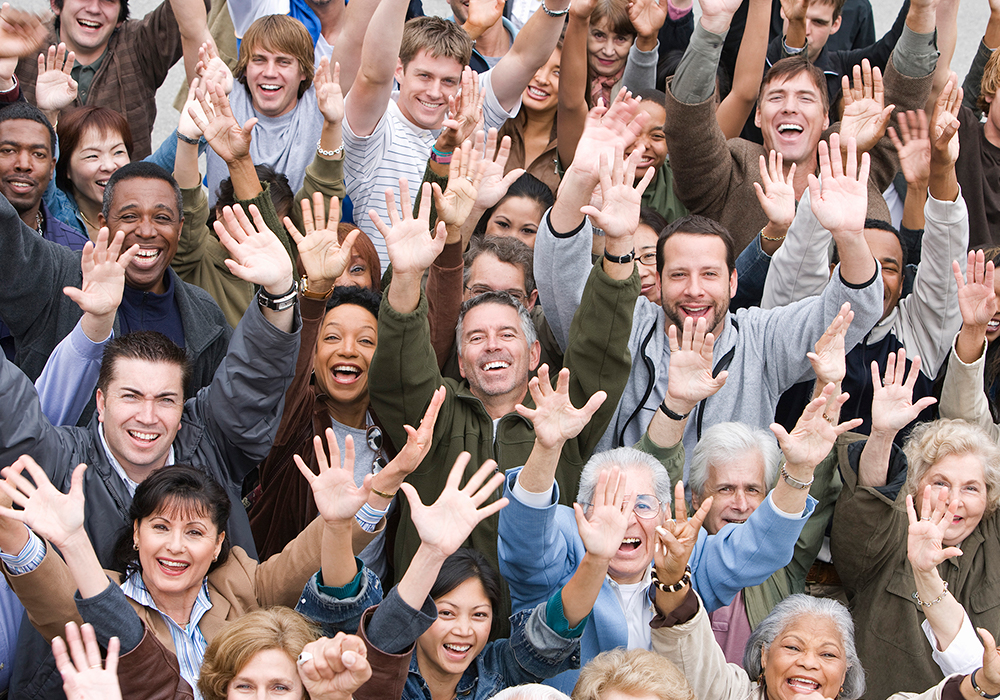 crowd holding up hands