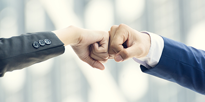 Two persons fistbumping 